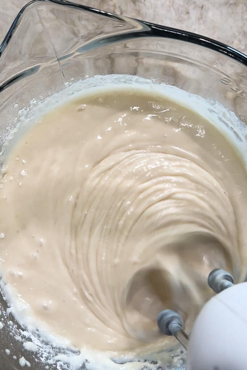 mixing white cake mix in a batter bowl