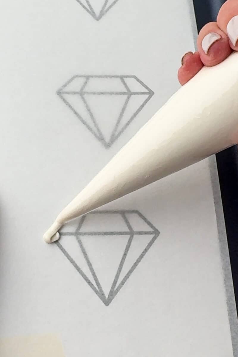 piping white chocolate melts over diamond