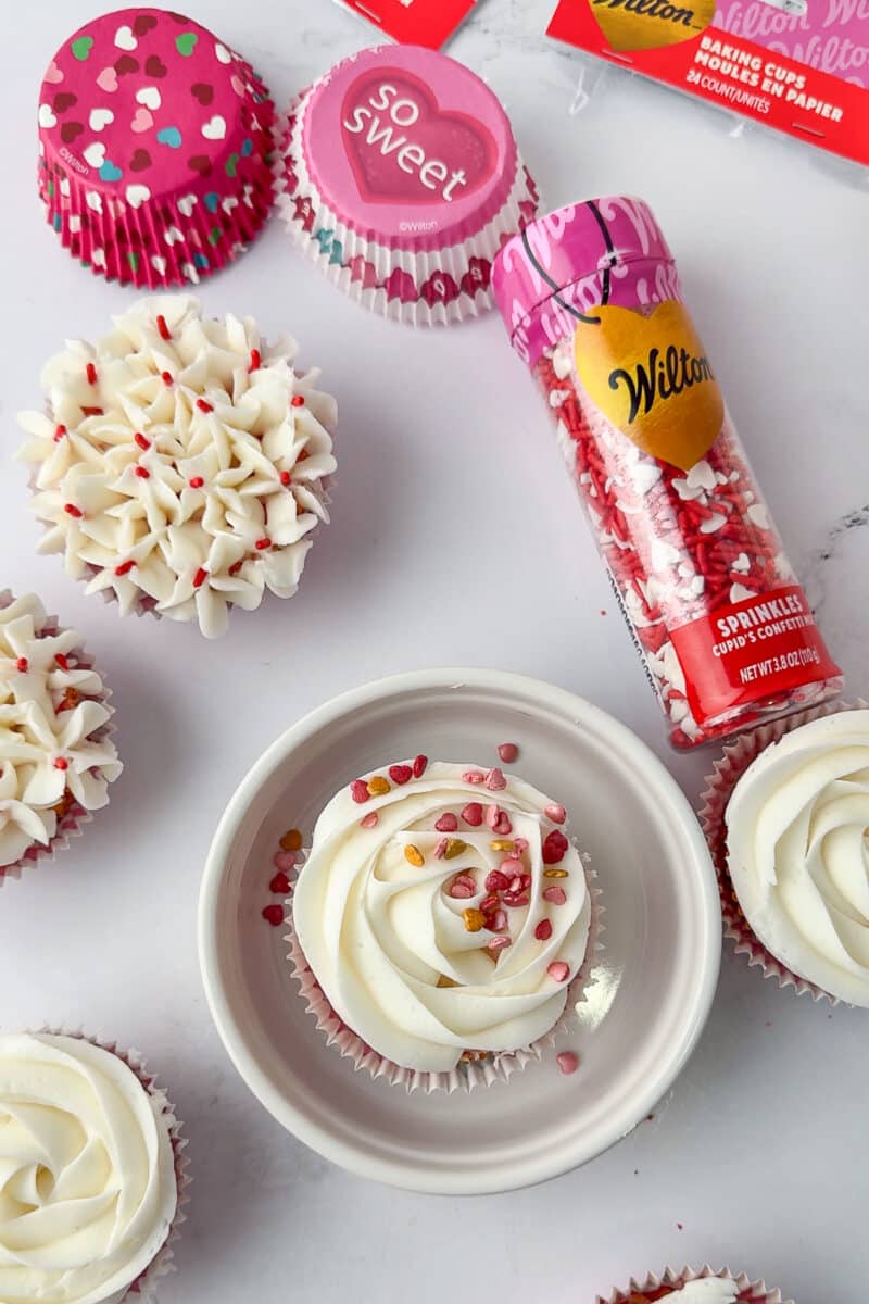 cupcake with sprinkles with white frosting and wilton sprinkles