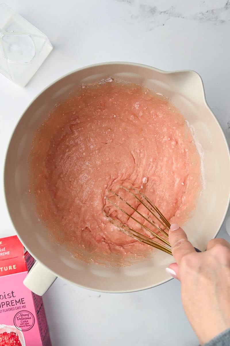 whisk in strawberry cake mix batter in batter bowl
