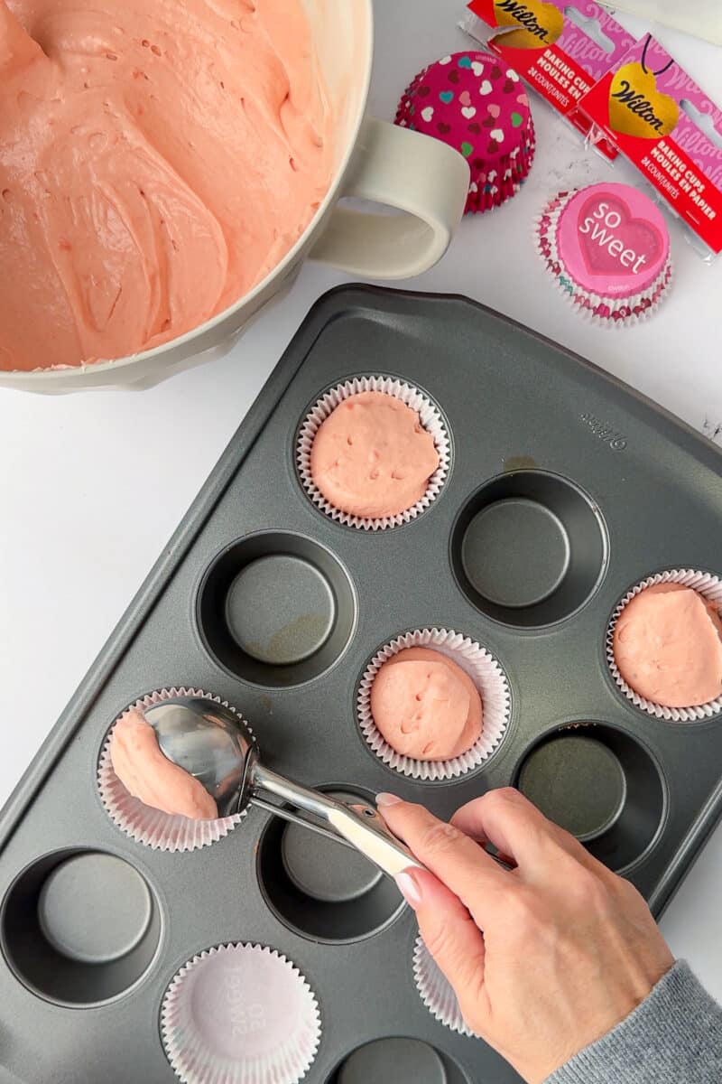 ice cream scoop placing batterinto wilton cup cake liner