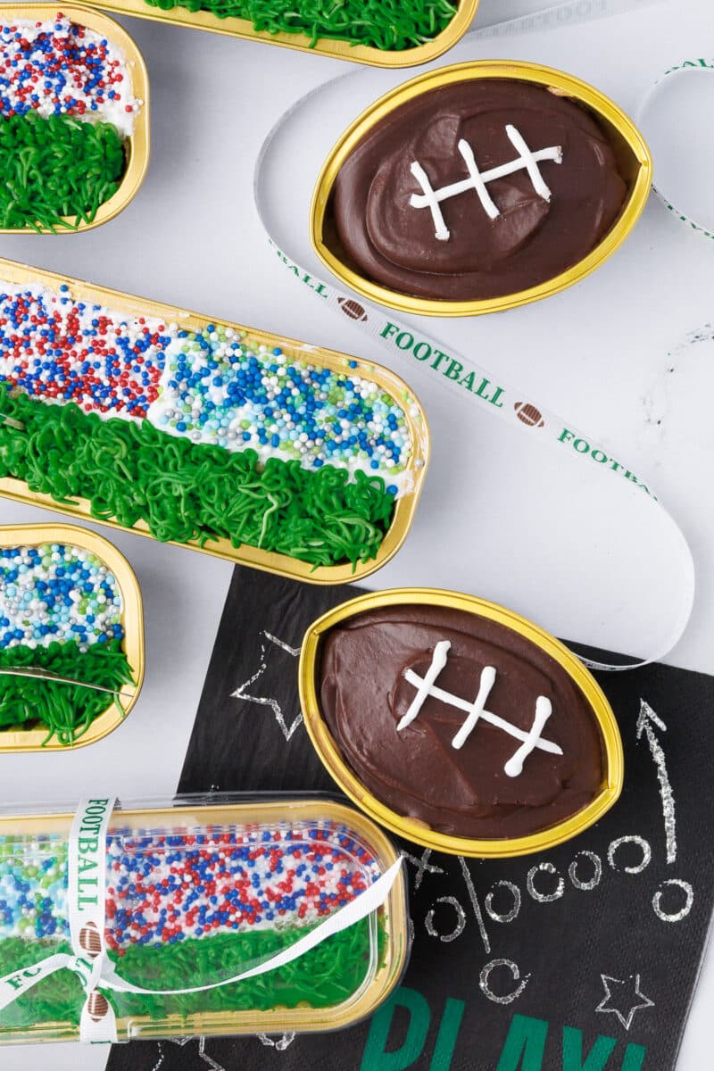 football shaped cupcakes on a counter with a stadium mini loaf pan