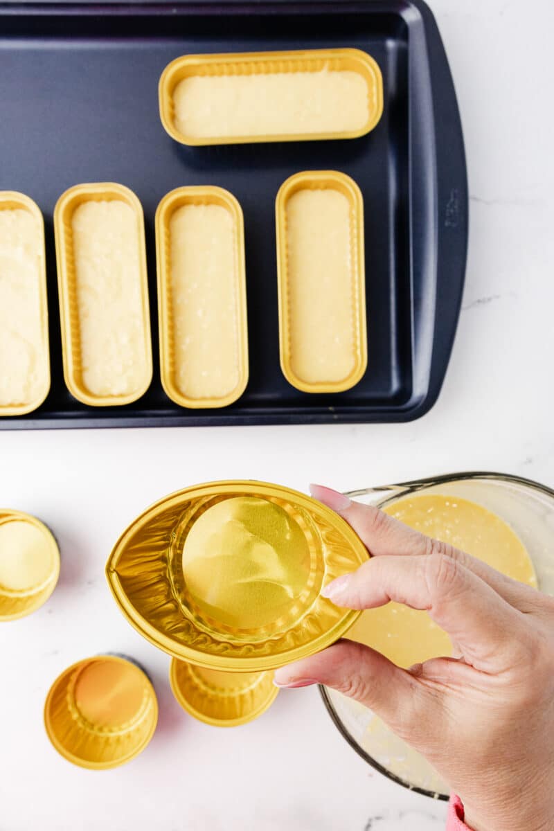 shaping an aluminum cupcake pan into a football shape
