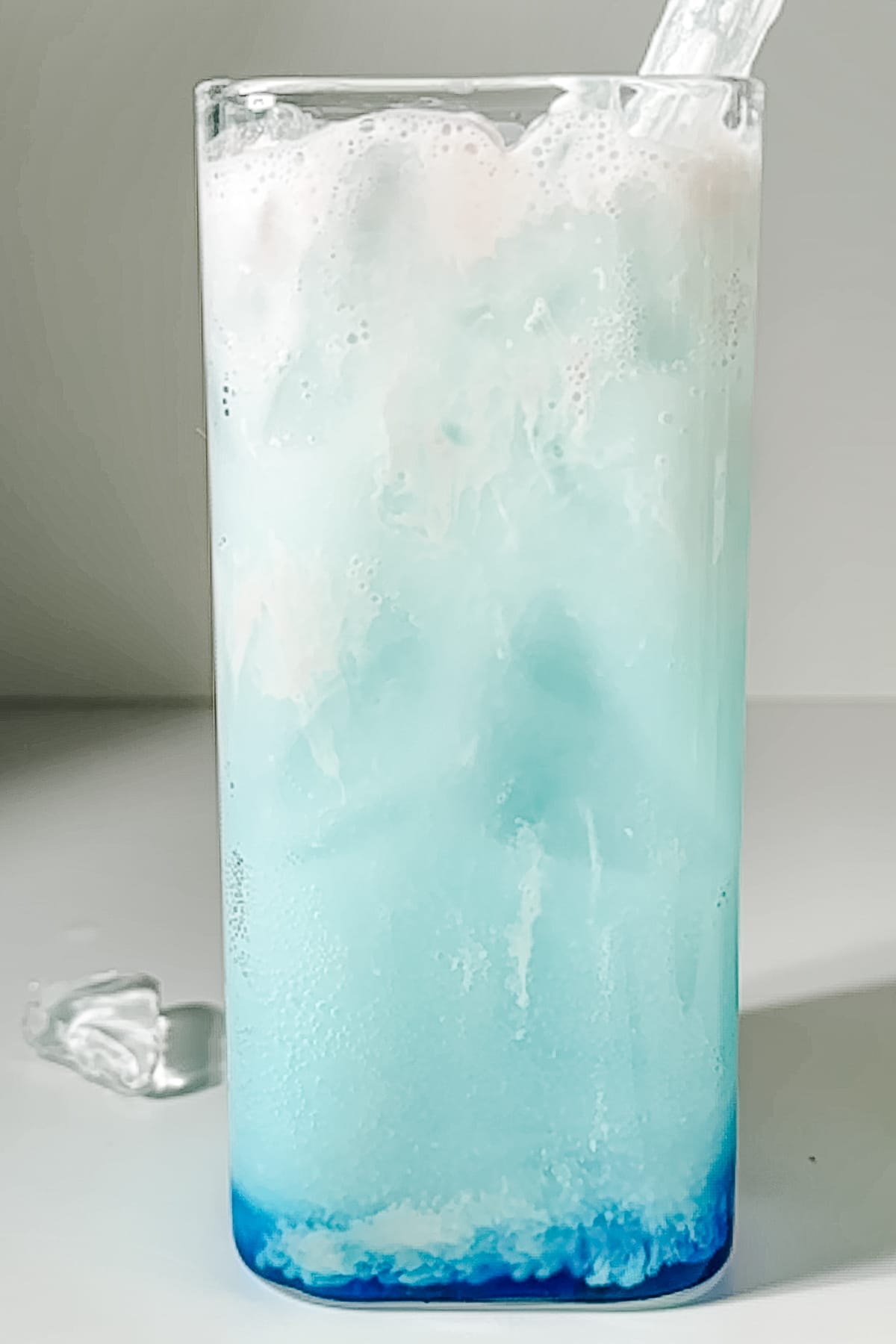 A finished Argentina Sparkler dirty soda with a light blue celeste color and creamy foam top.