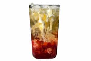Heavy cream swirling into a Strawberry Lemon Poppi soda, creating a marbled effect.